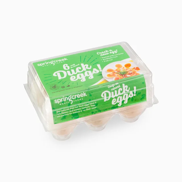 Carton of six duck eggs photographed on a white background